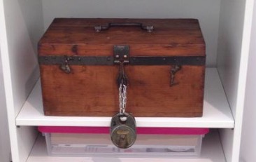 Wooden treasure box with large padlock